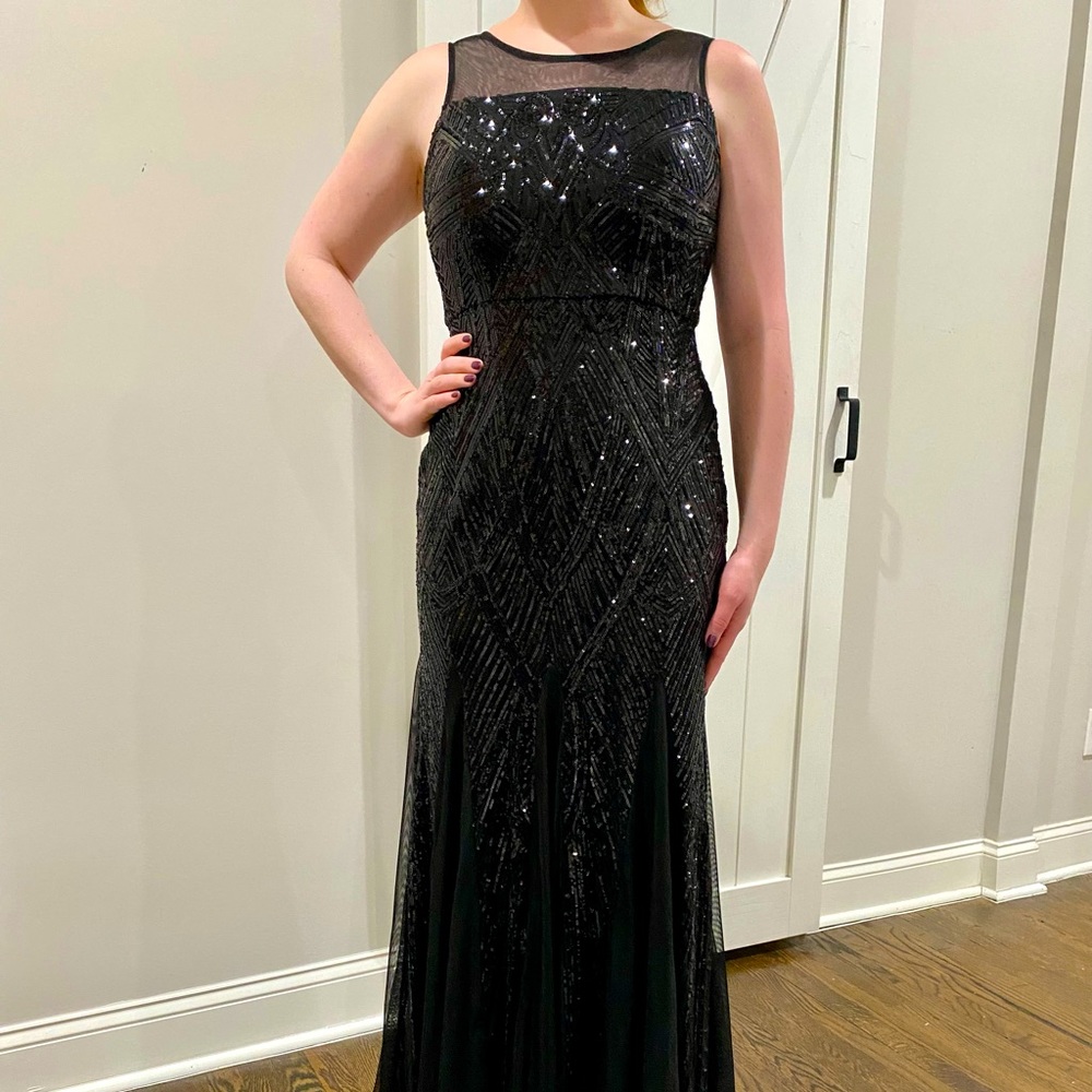 Sequined and sexy black evening gown with trumpet fit and allusion neckline